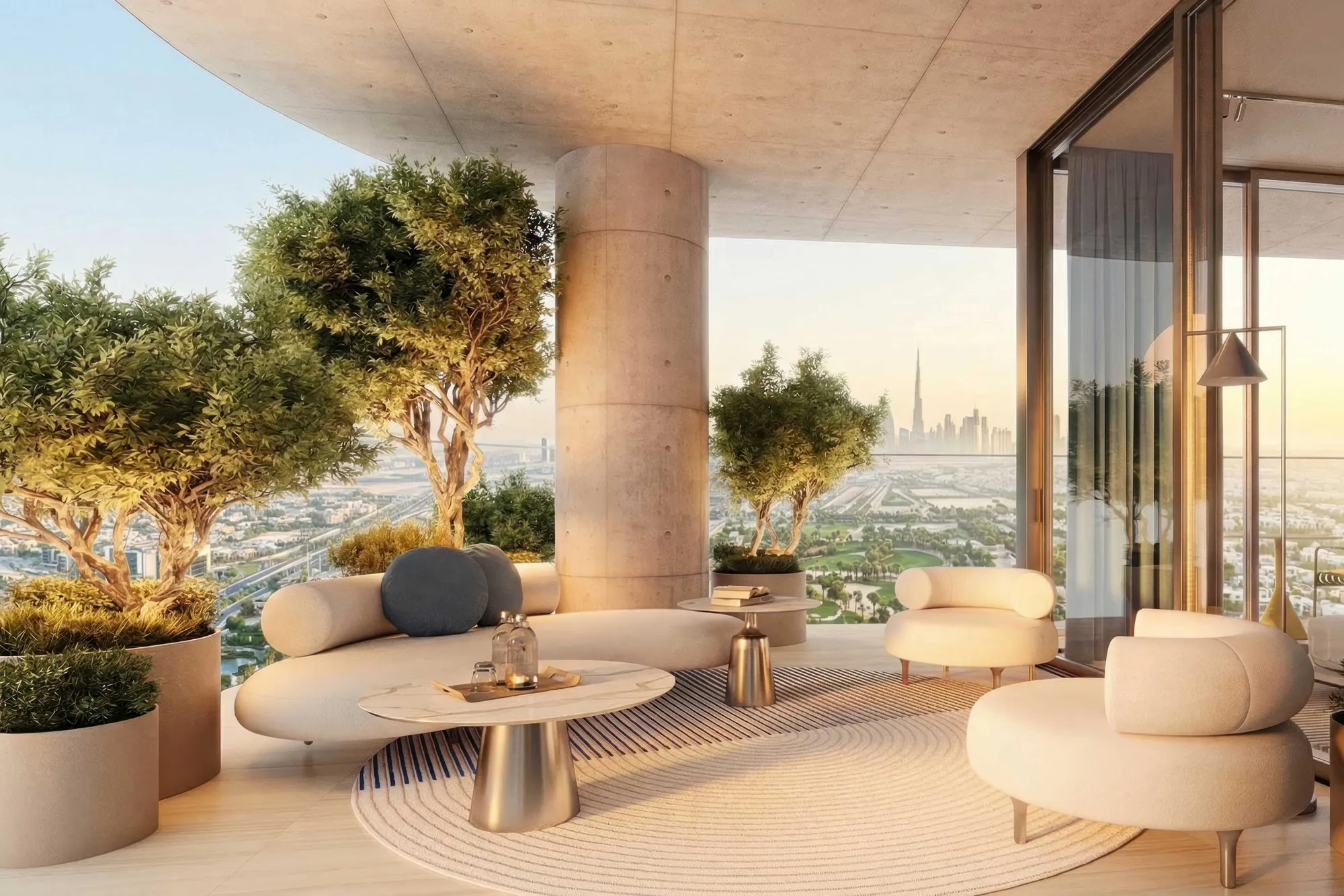 Corner balcony lounge with olive trees and distant Burj Khalifa